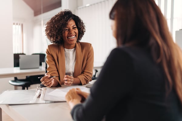 A female financial advisor sits with a client going over their account.